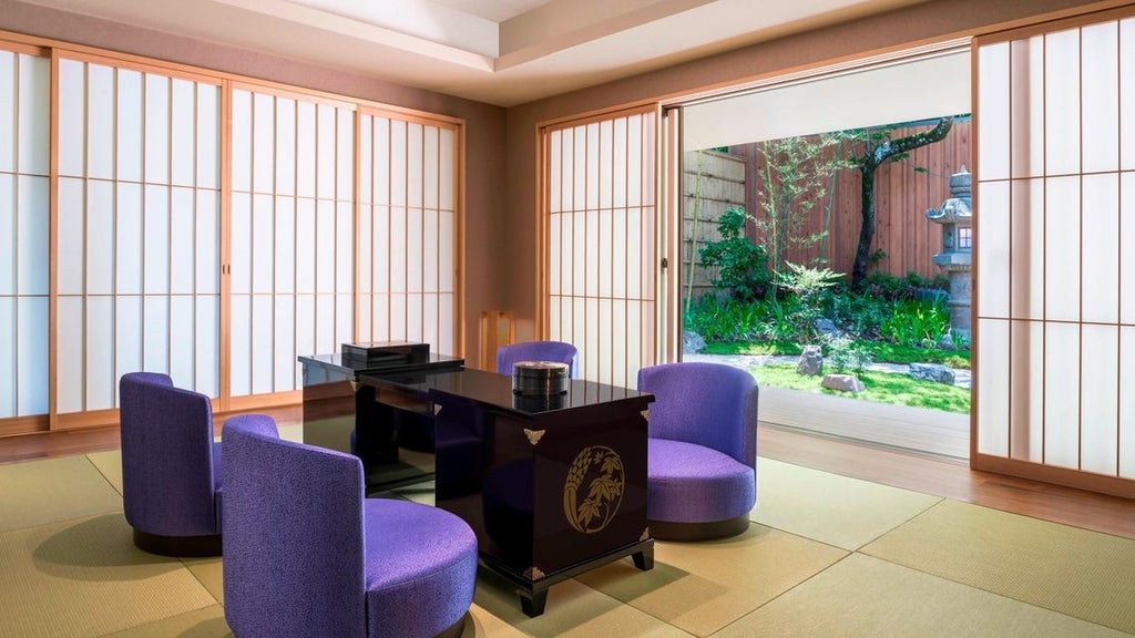 Opulent Kyoto hotel suite with traditional Japanese design, featuring elegant wood furnishings, soft lighting, and panoramic views of serene landscape