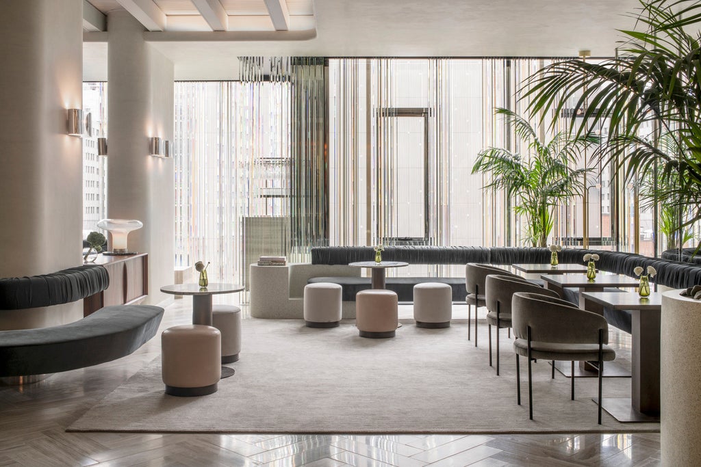 Elegant glass high-rise Four Seasons hotel in downtown Montreal featuring modern architecture and golden-lit windows at dusk