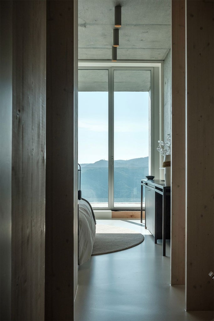 Luxurious Portuguese hotel room with panoramic mountain view, elegant contemporary design featuring wooden accents and sleek minimalist furnishings