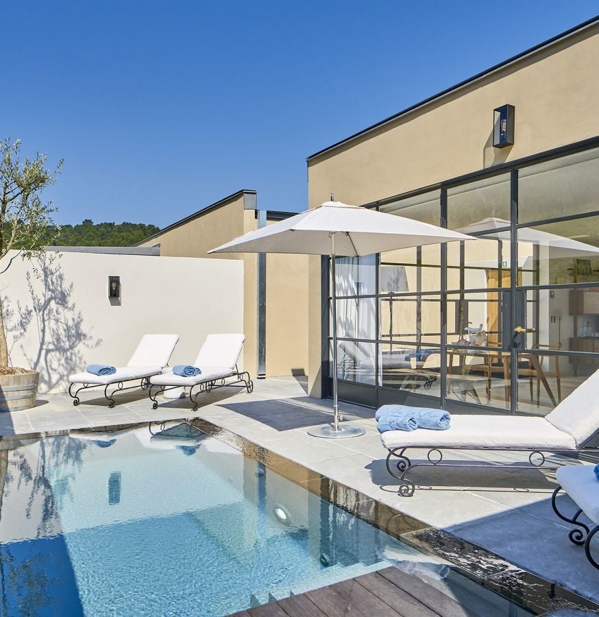 Lavish two-story villa suite with private infinity pool overlooking Provence vineyards, featuring floor-to-ceiling windows and modern design