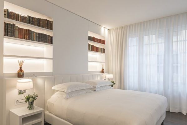 Luxurious junior suite at Magna Pars L'Hotel à Parfum, Milan, with elegant minimalist decor, soft neutral tones, and sophisticated design elements