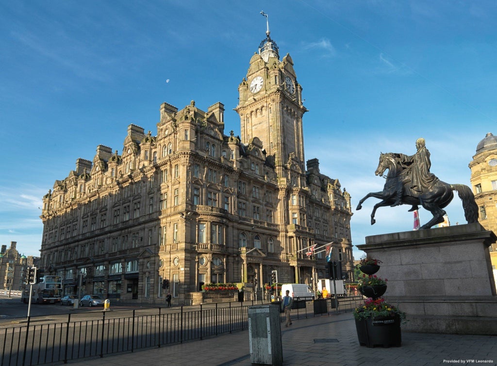 Clock tower and grand facade of The Balmoral Hotel, a Victorian-era luxury landmark with ornate sandstone architecture in Edinburgh