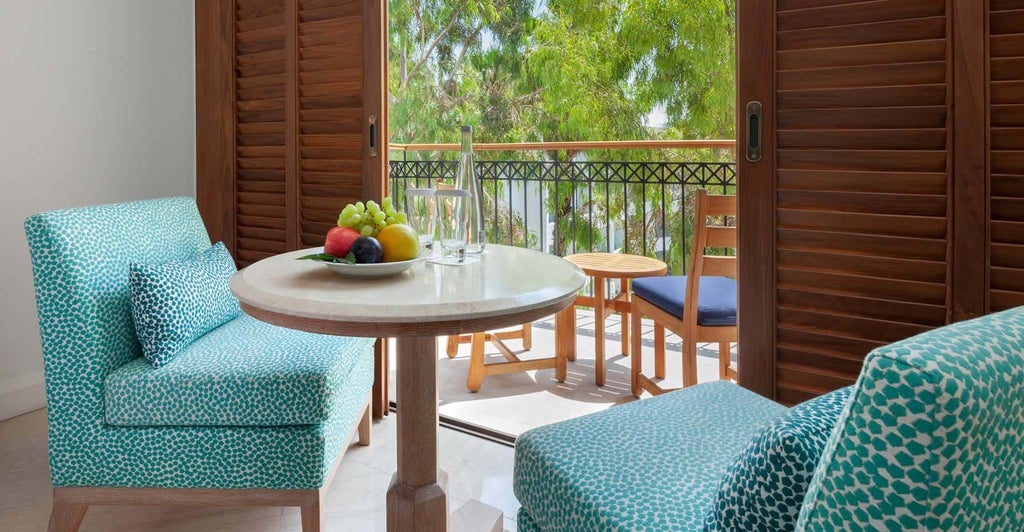 Elegant inland view hotel room at scenset resort with plush white bedding, modern minimalist decor, and soft neutral color palette highlighting Mediterranean design