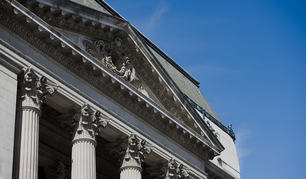 Elegant boutique hotel exterior with Victorian architecture, ornate facade, and chic modern design in central urban setting, showcasing luxurious hospitality ambiance