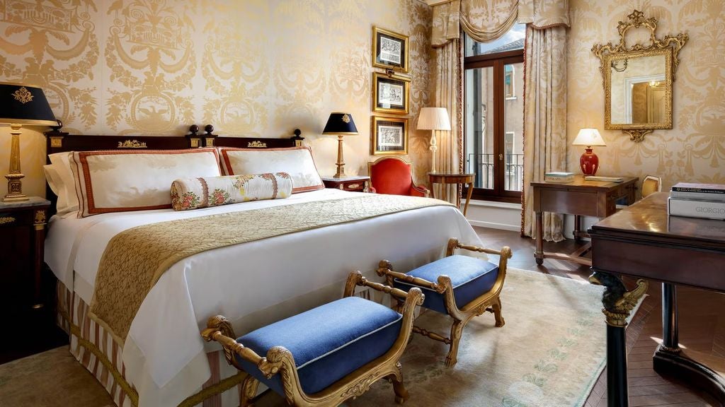 Opulent Venetian suite featuring antique furnishings, gilded mirrors, ornate chandeliers, high ceilings and views of the Grand Canal