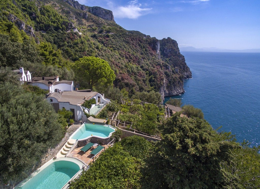 Elegant medieval watchtower villa on Amalfi cliffside with terraced gardens, lemon groves and private sea access showcasing l