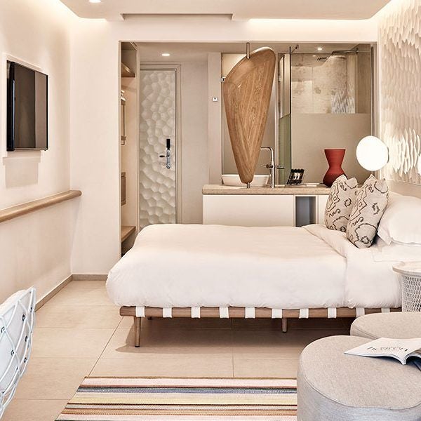 Luxurious white-washed Horizon Superior Room at Myconian Kyma hotel, featuring minimalist design and stunning Aegean Sea panoramic view from private balcony