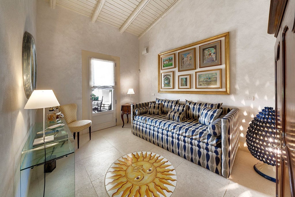 Elegant Sicilian luxury suite with soft cream walls, ornate headboard, and delicate lace curtains revealing historic Mediterranean garden landscape