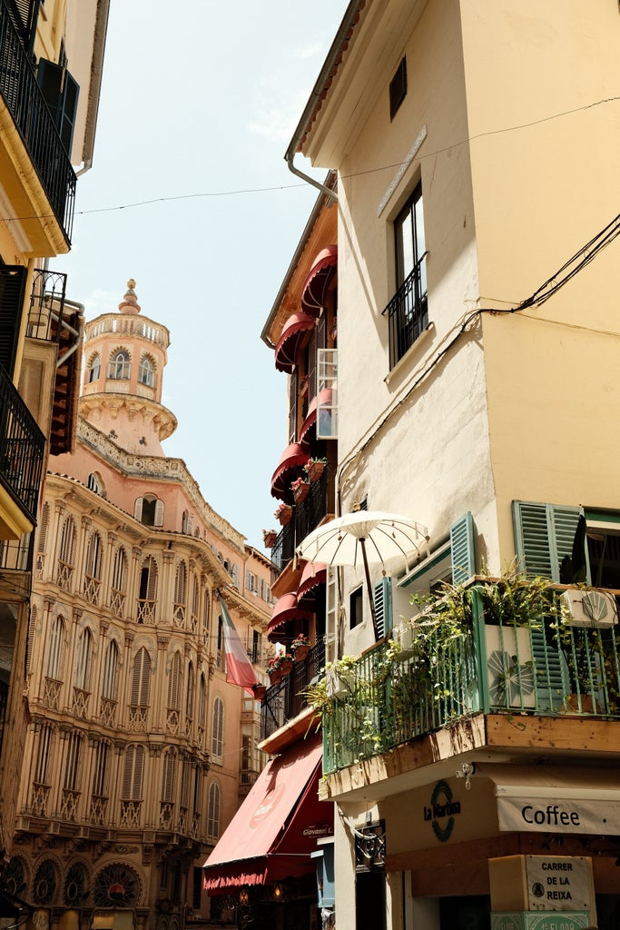 Historic Palma de Mallorca walking tour through elegant limestone streets, featuring ornate Mediterranean architecture and sunlit cathedral backdrop