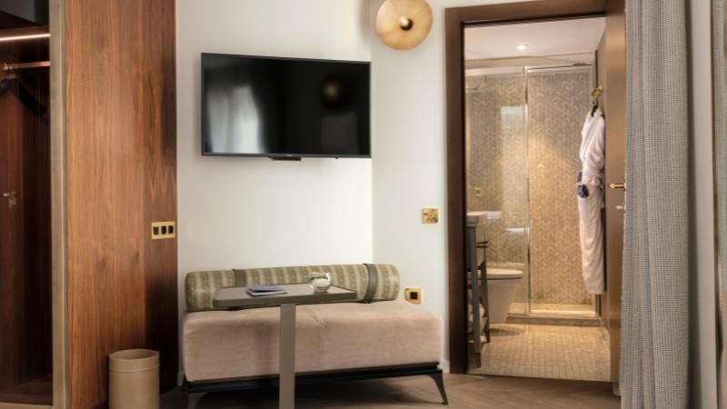 Elegant Parisian hotel room with soft neutral tones, modern minimalist design, plush white bedding, and sophisticated urban chic decor at Scenset Maison Bréguet