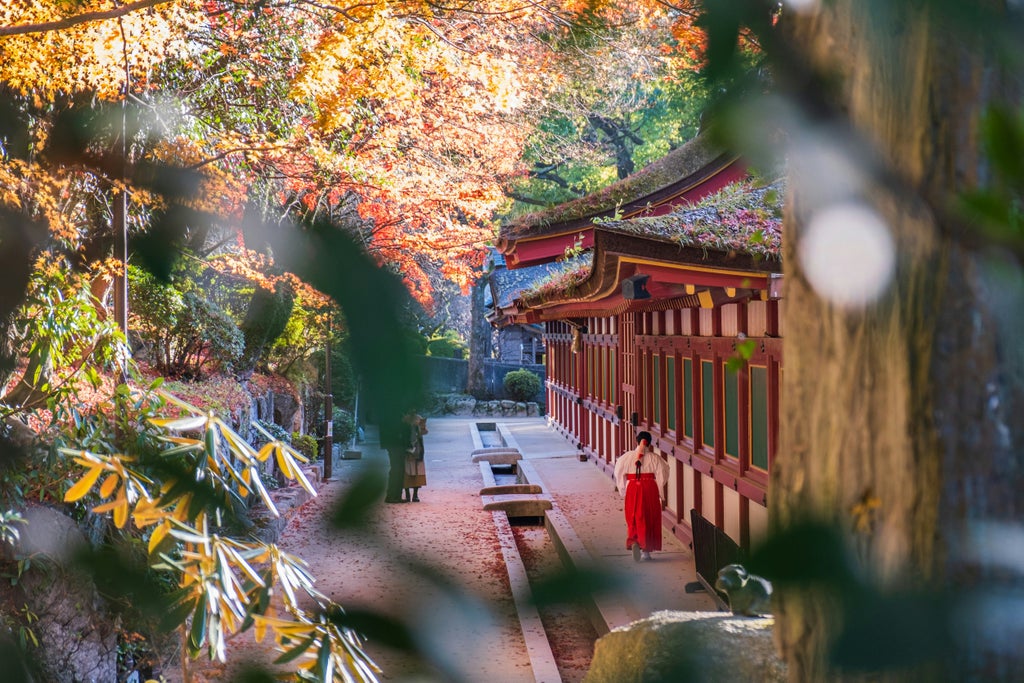 Elegant travelers exploring traditional Dazaifu Tenmangu Shrine with ornate torii gates and lush gardens in Fukuoka, Japan's scenic cultural landscape