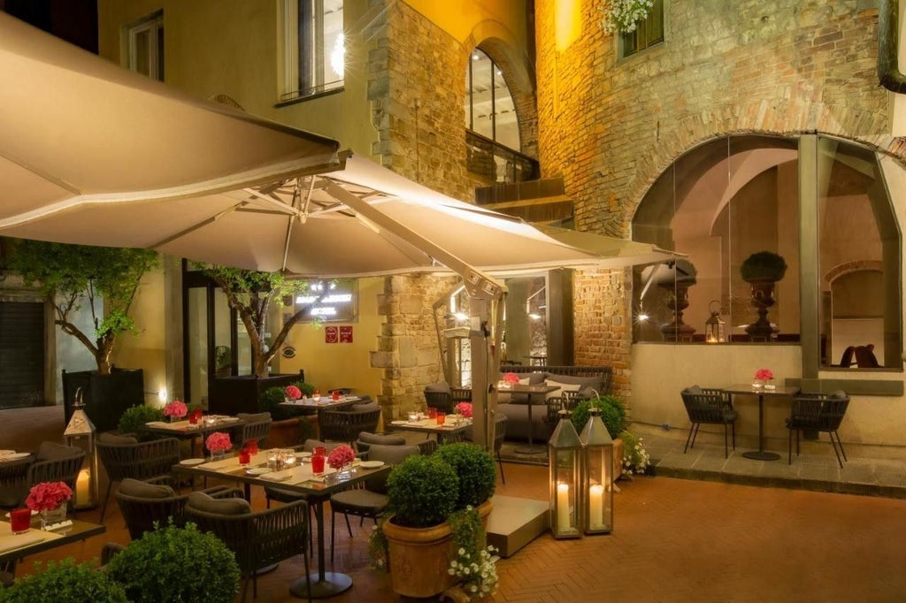 Hotel Brunelleschi's elegant stone facade in Florence features arched windows, classic Italian architecture, and a historic tower entrance