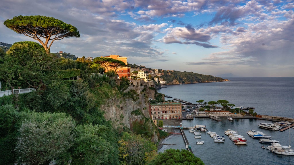 Dramatic aerial view of Positano's pastel-colored villas cascading down cliffs to turquoise Mediterranean waters along Amalfi Coast