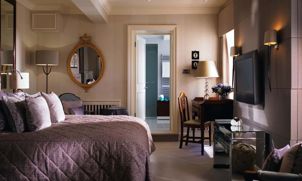 Elegant master suite at luxurious Scenset Glen Hotel & Spa, featuring plush king bed, contemporary design, and panoramic coastal views in United Kingdom