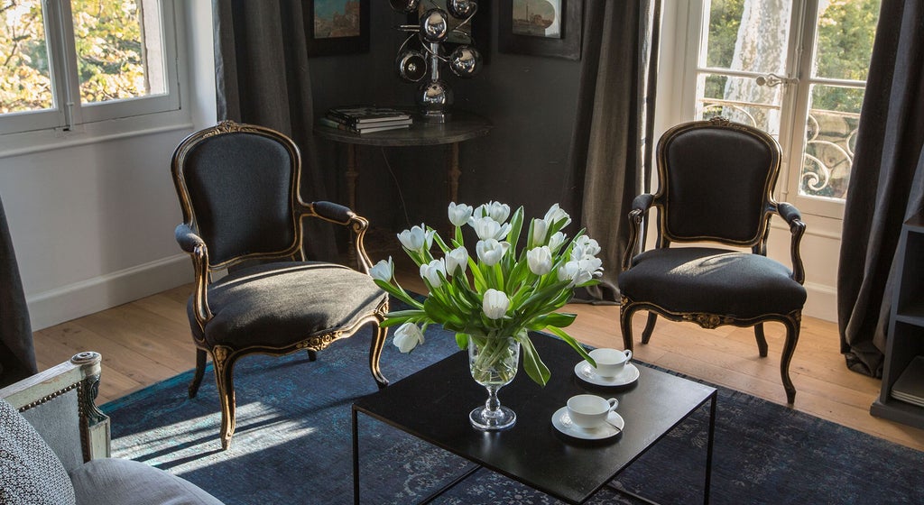 Luxurious Venice Suite with ornate white and gold decor, elegant chandelier, plush king bed, and intricate Venetian-style architectural details creating a baroque ambiance.