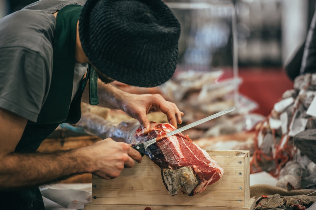 People explore artisanal food shops in Parma's historic center, sampling premium Parmigiano-Reggiano, prosciutto and local delicacies