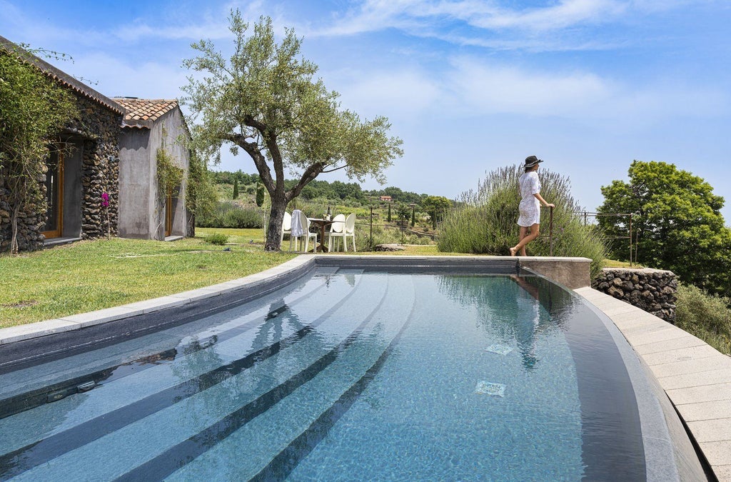 Elegant two-bedroom pool villa at Monaci delle Terre Nere, nestled in Sicilian countryside with modern furnishings and sweeping volcanic landscape views