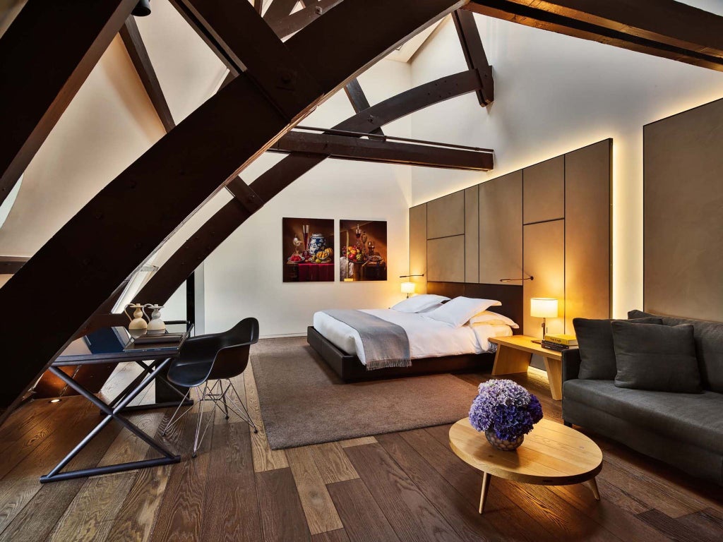 Luxurious rooftop suite at Conservatorium Hotel with panoramic Amsterdam skyline, modern minimalist design, expansive windows, and elegant contemporary furnishings