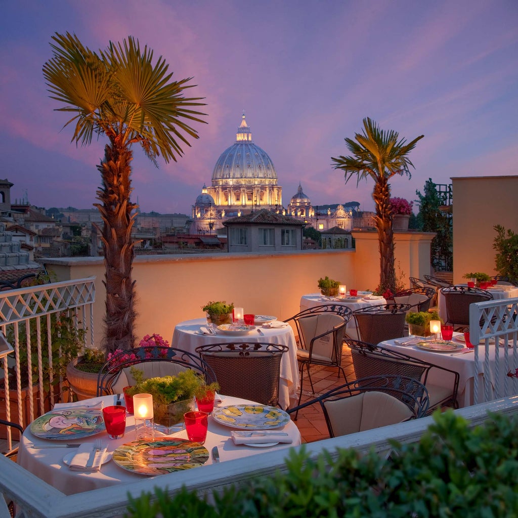 Elegant 5-star Italian hotel exterior with ivy-covered stone walls, ornate balconies, and classic Renaissance architecture in warm sunlight