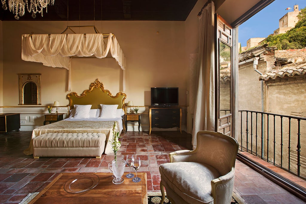 Elegant Spanish colonial hotel with ornate wrought-iron balconies, terracotta walls, and classic arched windows in historic Granada