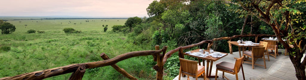 Elegant safari tent suite at Bateleur Camp Kenya, with private deck overlooking savanna, canvas walls and colonial-style furniture