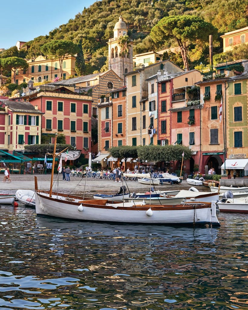 Cliffside luxury hotel overlooking Mediterranean Sea, with infinity pool, white terraces and elegant lounge areas nestled in Amalfi coast