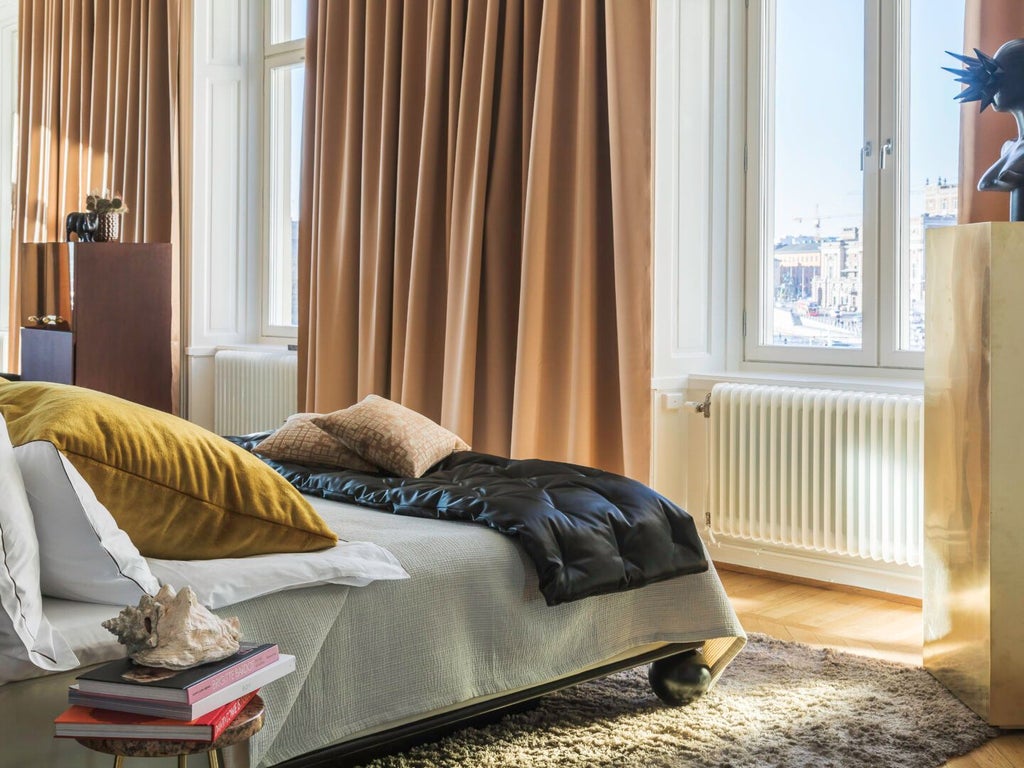 Luxurious king-sized hotel room at Lydmar Hotel with plush bedding, elegant contemporary design, and soft neutral color palette in Stockholm, Sweden