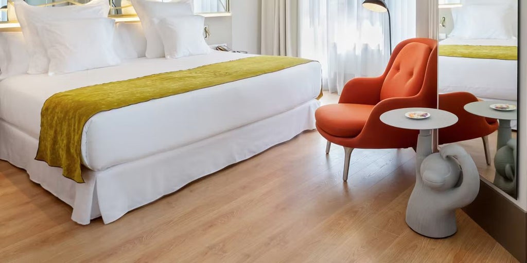 Elegant premium hotel room at Barceló Torre de Madrid with modern design, sleek furnishings, city skyline view, and sophisticated neutral color palette