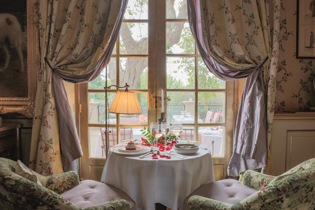 Elegant lavender-lined terrace of Villa Gallici, a luxurious boutique hotel nestled in the heart of Provence, with soft pastel-colored stone facade