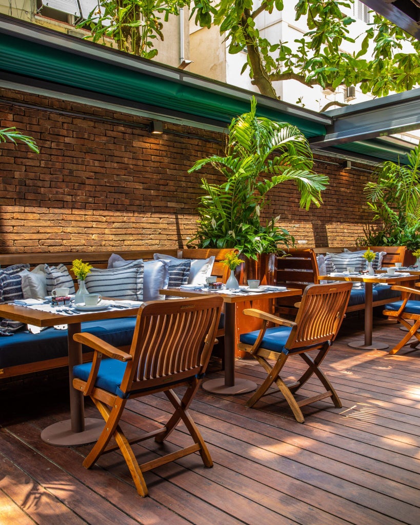 Luxurious rooftop pool overlooking scenic Ipanema Beach, with sleek architectural design and panoramic views of Rio's coastline and mountains