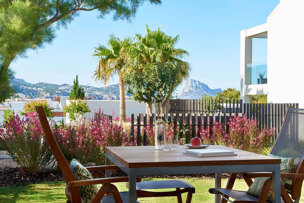 Luxurious 2-bedroom Garden Pool Suite at 7Pines Resort, Ibiza, featuring elegant white decor, private pool, and stunning Mediterranean landscape view