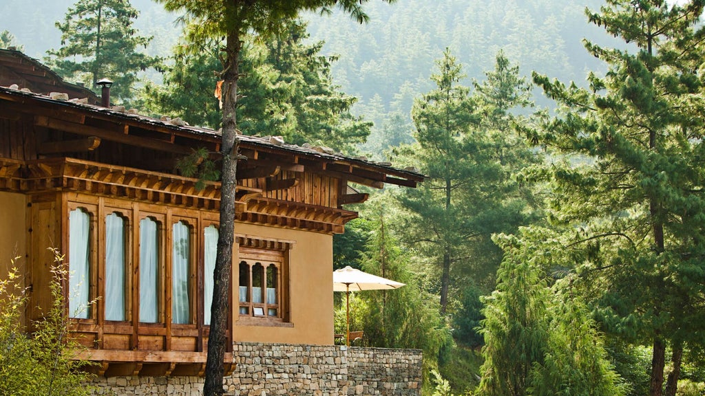 Spacious one-bedroom villa with traditional Bhutanese design, featuring wooden floors, elegant furnishings, and panoramic mountain views through large windows