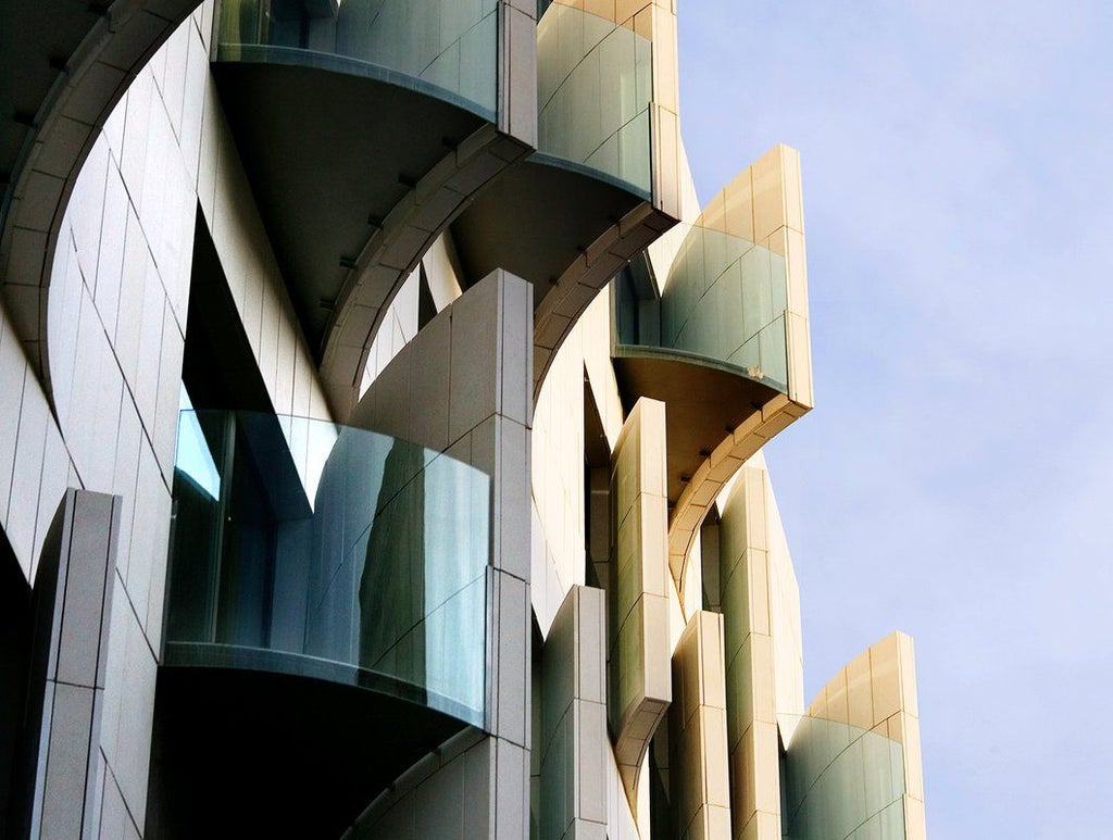 Modern luxury hotel facade with sleek architectural design, minimalist white exterior, urban Barcelona setting, reflecting contemporary Spanish hospitality aesthetics