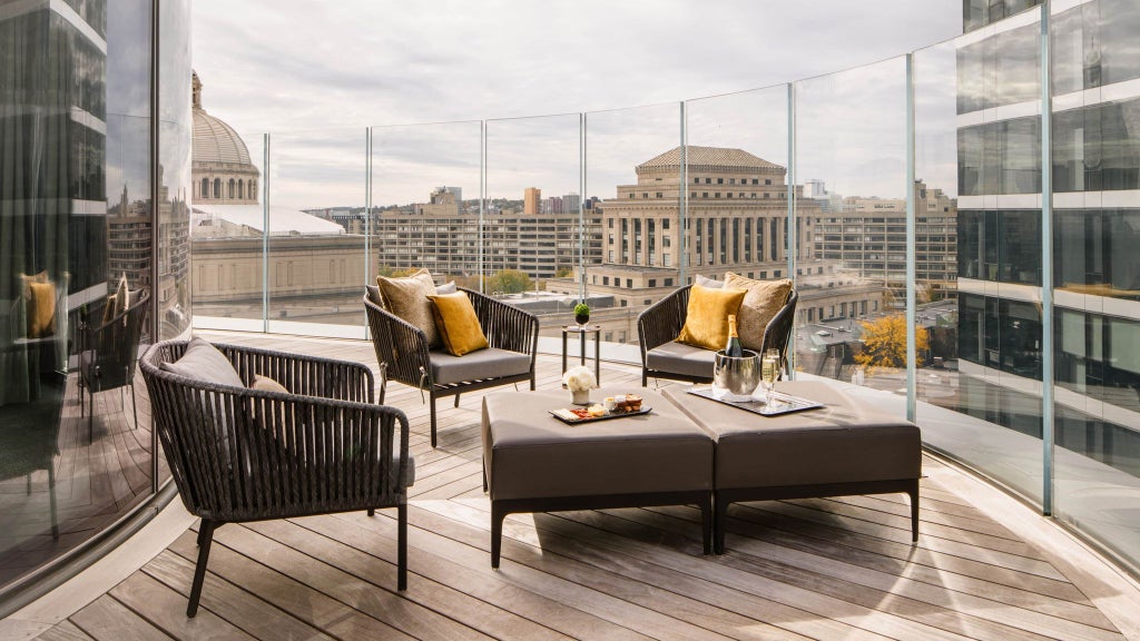 Luxurious Charles Suite at Four Seasons Hotel with elegant modern decor, city skyline view, plush king bed, and sophisticated neutral color palette