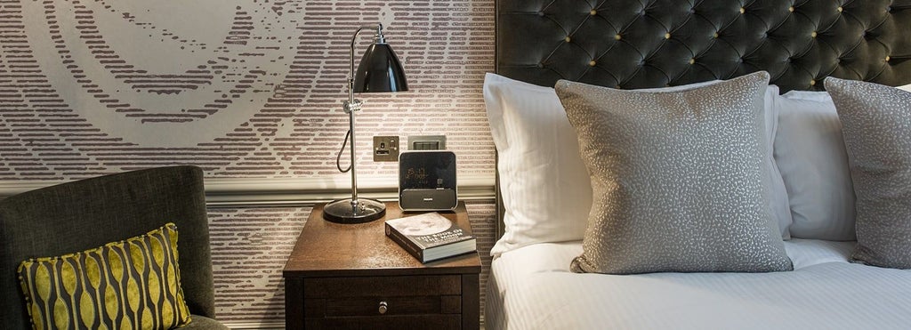 Elegant single and double hotel rooms at The Scenset Hotel, featuring luxurious design with refined furnishings and sophisticated neutral color palette in the United Kingdom.