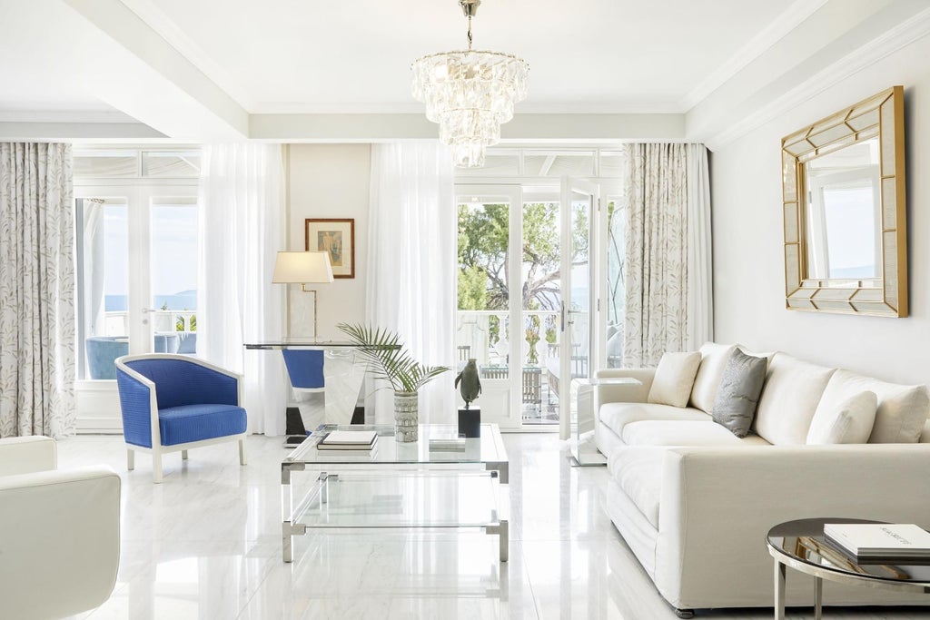 Luxurious Two Bedroom Suite overlooking azure Aegean Sea, featuring contemporary design, private balcony, and panoramic coastal views of scenic Greece