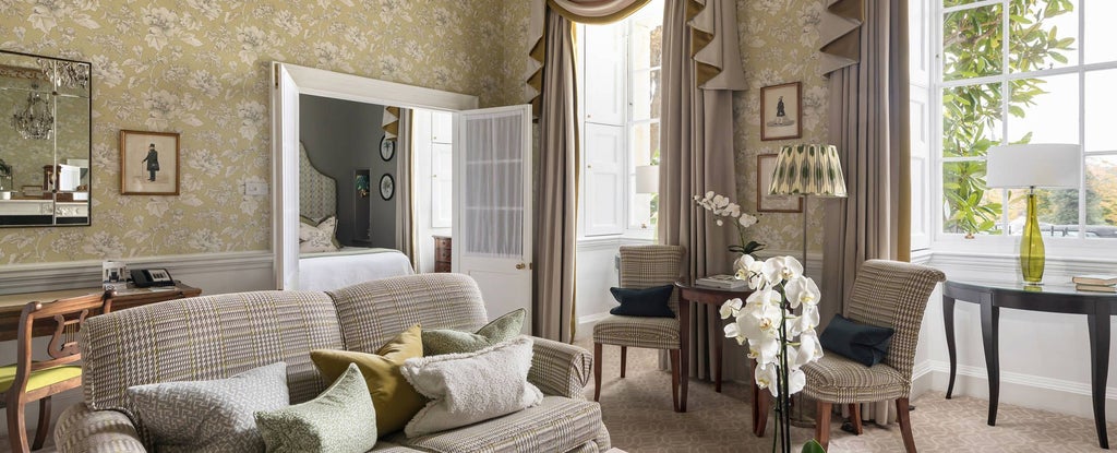 Elegant Georgian-style deluxe suite at luxury spa hotel, featuring ornate period furnishings, soft neutral tones, and sophisticated architectural details of historic British design