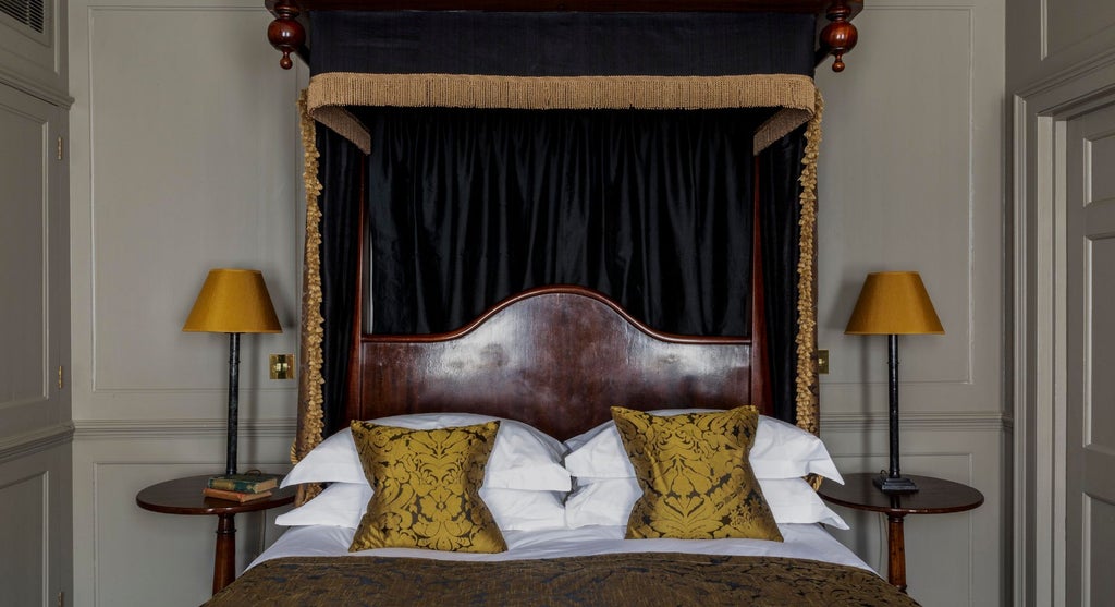 Elegant superior double room at Hazlitt's, featuring plush bedding, historic decor, and refined classic British interior with warm lighting and luxurious textures