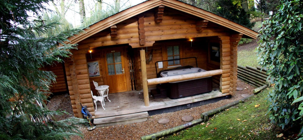 Elegant wood-paneled hotel room with plush bedding, vintage furnishings, and warm ambient lighting at scenic countryside lodging in United Kingdom