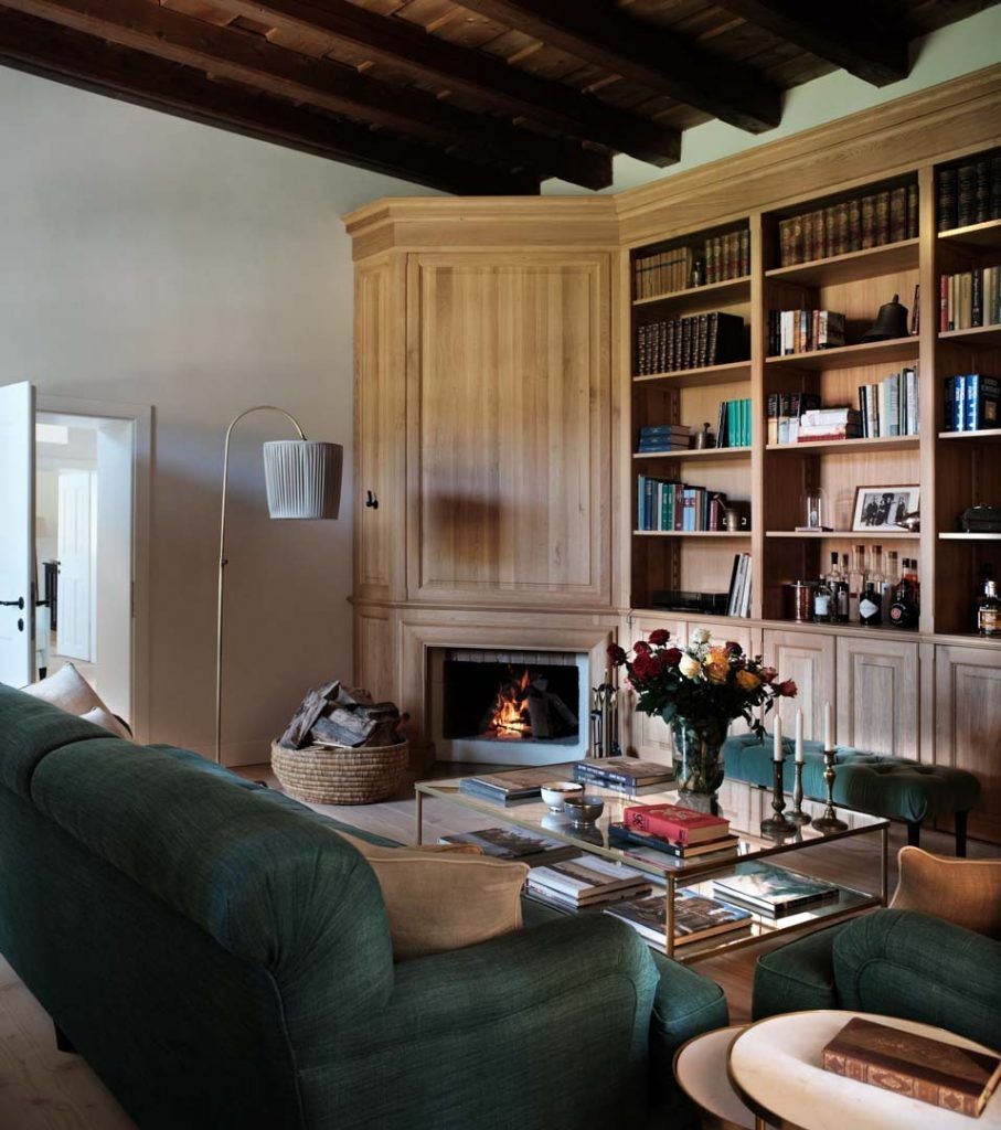 Rustic wooden interior of a luxurious Transylvanian caretaker's house with traditional textiles, antique furniture, and warm ambient lighting.