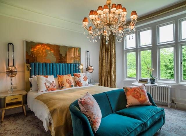 Luxurious hotel room with plush white bedding, elegant furnishings, hardwood floors, and soft lighting at Homewood Hotel & Spa in the United Kingdom