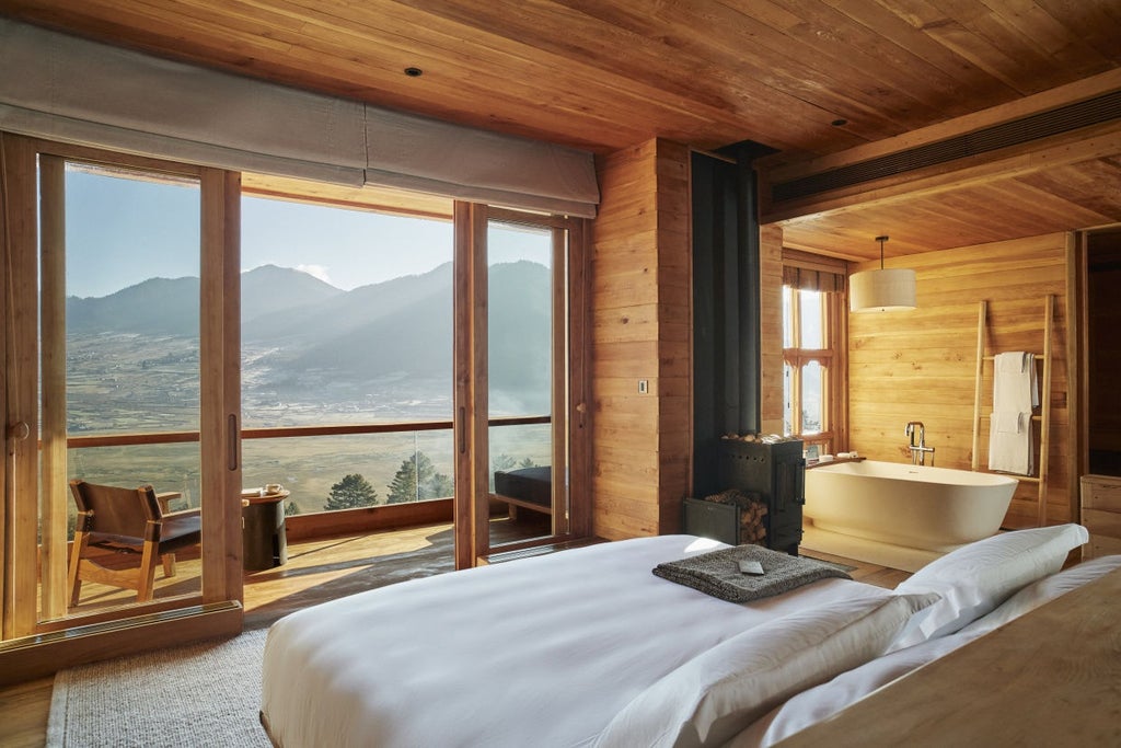 Luxurious mountain lodge with floor-to-ceiling windows overlooking Bhutan's pristine valley, featuring timber architecture and natural stone walls