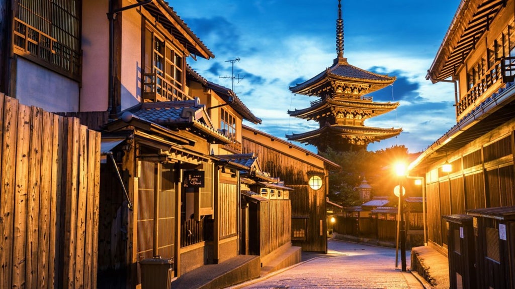 Elegant traditional Japanese ryokan-style luxury hotel nestled by a serene river in Kyoto, featuring wooden architecture and lush garden landscaping at sunset