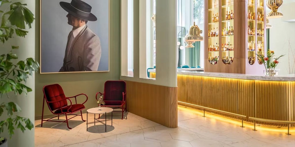 Luxurious Barceló Torre hotel exterior at dusk, featuring modern architectural design with glass facade overlooking Madrid's historic cityscape