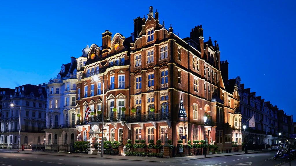 Elegant Victorian-era luxury hotel facade with ornate windows, cream-colored exterior, and classic architectural details in London's prestigious neighborhood