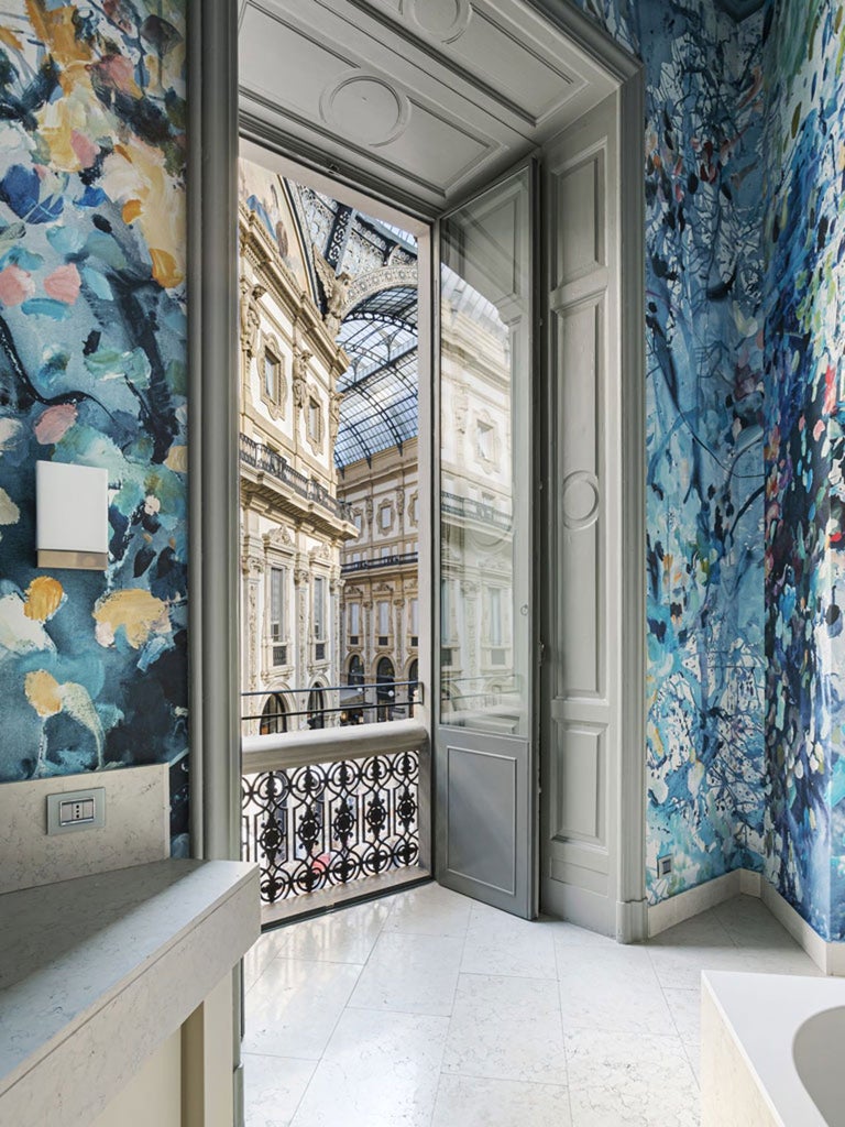 Luxurious art-filled hotel lobby with marble floors, grand chandelier, and contemporary design in modern Milan, Italy, featuring elegant architectural details