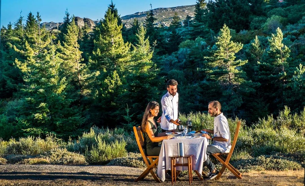 Luxurious mountain retreat nestled in Portuguese landscape, white modernist hotel blending seamlessly with rugged Serra da Estrela alpine terrain and verdant surroundings