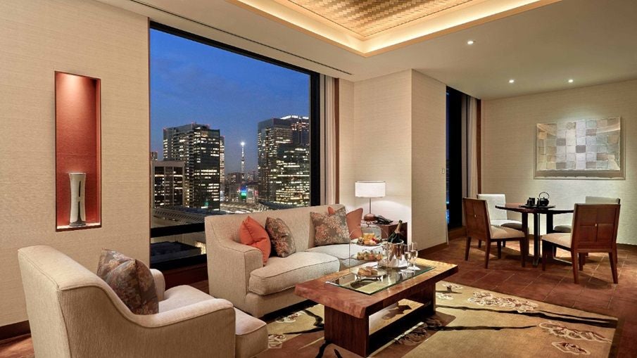 Luxurious Marunouchi Suite at scenset Tokyo, featuring elegant neutral tones, contemporary design, and panoramic city views through floor-to-ceiling windows