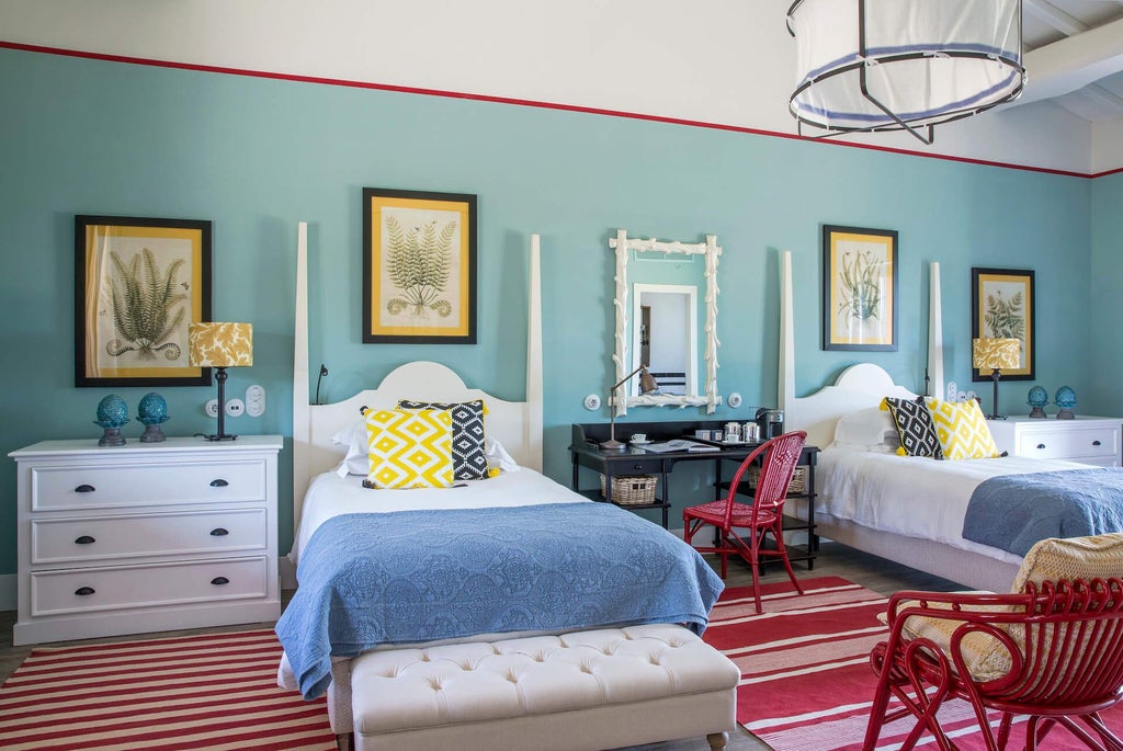 Elegant Tuscan-style deluxe junior suite with two queen beds, rustic stone walls, warm wood furnishings, and soft natural lighting at Locanda Rossa