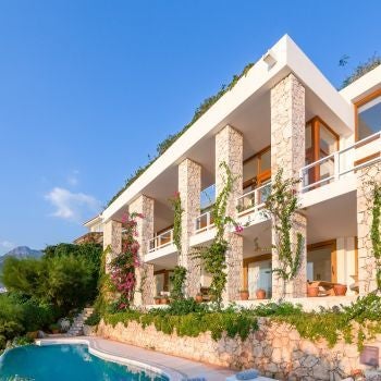 Luxurious Turkish villa suite with white minimalist design, expansive sea view, private pool, and elegant coastal landscape through floor-to-ceiling windows